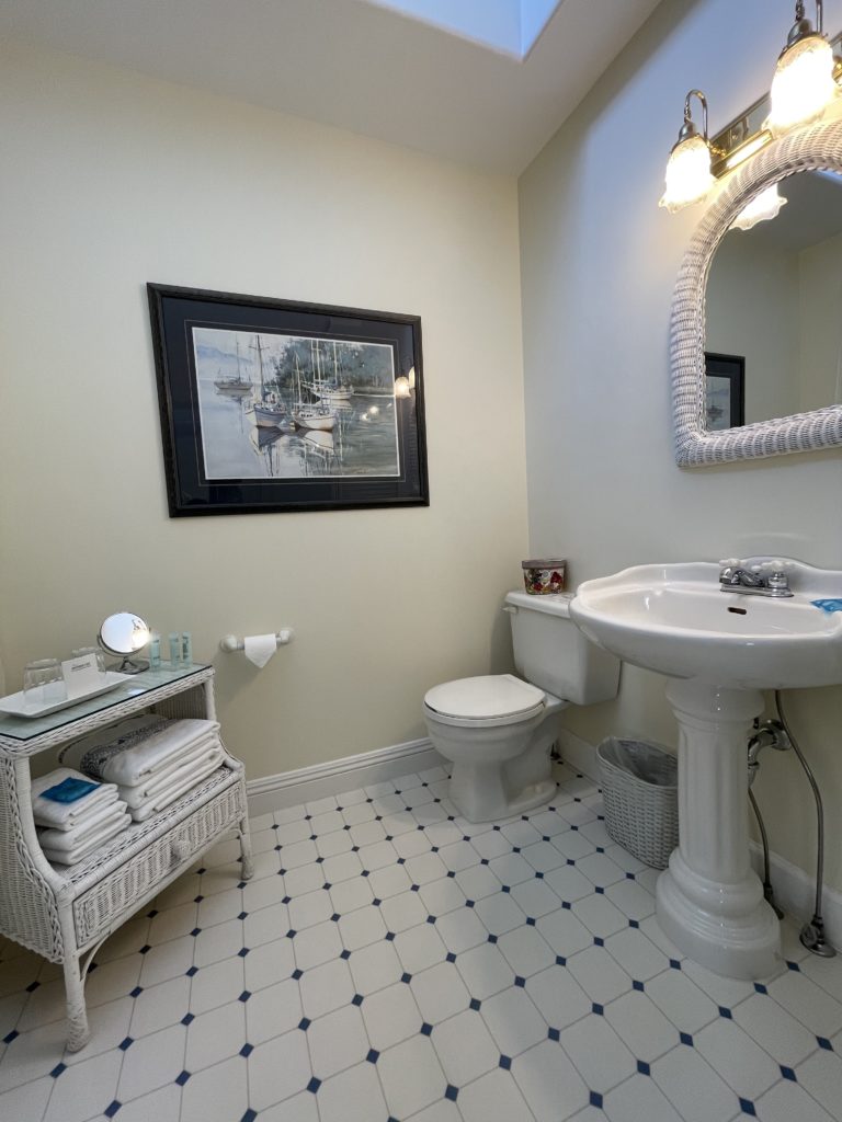 Private bathroom with a charming pedestal sink